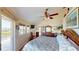 Comfortable bedroom featuring a king-sized bed, ceiling fan, ensuite bath, and a dresser at 19170 Aviation Ct, Port Charlotte, FL 33948