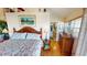 Comfortable bedroom featuring a king-sized bed, ceiling fan, ensuite bath, and a dresser at 19170 Aviation Ct, Port Charlotte, FL 33948