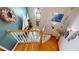 View of a staircase with a white railing and decorations on the wall, looking down to the front door at 19170 Aviation Ct, Port Charlotte, FL 33948