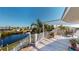 Stunning waterfront view of the canal from a large balcony with furniture at 19170 Aviation Ct, Port Charlotte, FL 33948