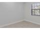 Bright bedroom featuring neutral walls, tiled floors, and a window with blinds at 19505 Quesada Ave # Ss102, Port Charlotte, FL 33948