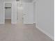 Bright bedroom with doorways to the bathroom and walk-in closet at 19505 Quesada Ave # Ss102, Port Charlotte, FL 33948