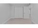 Bright bedroom featuring a double door closet, neutral walls, and tiled floors at 19505 Quesada Ave # Ss102, Port Charlotte, FL 33948