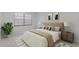 Comfortable bedroom with neutral decor, large window, and cozy furnishings at 19505 Quesada Ave # Ss102, Port Charlotte, FL 33948