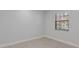 Bright bedroom featuring neutral walls, tiled floors, and a window with blinds at 19505 Quesada Ave # Ss102, Port Charlotte, FL 33948