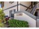 Condo building entrance with unit numbers and landscaped bushes at 19505 Quesada Ave # Ss102, Port Charlotte, FL 33948