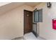 View of the unit's front door, showing the door itself, peephole, and adjacent window at 19505 Quesada Ave # Ss102, Port Charlotte, FL 33948
