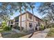 Exterior view of a two-story condo with palm trees and manicured landscaping at 19505 Quesada Ave # Ss102, Port Charlotte, FL 33948