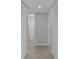 Hallway leading to bathroom, with closet space on both sides at 19505 Quesada Ave # Ss102, Port Charlotte, FL 33948
