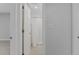 Hallway leading to bathroom, with closet space on both sides at 19505 Quesada Ave # Ss102, Port Charlotte, FL 33948
