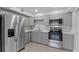 Beautiful kitchen featuring stainless steel refrigerator and appliances, and gray cabinetry at 19505 Quesada Ave # Ss102, Port Charlotte, FL 33948
