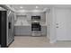 Updated kitchen with stainless steel refrigerator and appliances and modern gray cabinets at 19505 Quesada Ave # Ss102, Port Charlotte, FL 33948
