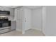 Bright kitchen with stainless steel appliances, white front door and gray cabinets at 19505 Quesada Ave # Ss102, Port Charlotte, FL 33948