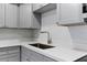 Close up of sink, quartz countertop and modern gray cabinets at 19505 Quesada Ave # Ss102, Port Charlotte, FL 33948
