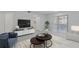 Spacious living room featuring a large TV, modern furniture, and ample natural light at 19505 Quesada Ave # Ss102, Port Charlotte, FL 33948