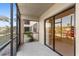 Enclosed patio showcasing a screen door leading to a rock garden and sliding glass doors at 19505 Quesada Ave # Ss102, Port Charlotte, FL 33948