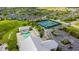 An aerial view of community pool, tennis courts, and parking area at 2040 Willow Hammock Cir # 208, Punta Gorda, FL 33983