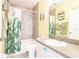 Bathroom featuring shower/tub combo with green botanical shower curtain, toilet, and vanity at 2040 Willow Hammock Cir # 208, Punta Gorda, FL 33983