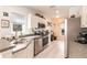 Bright kitchen features stainless steel appliances, tile flooring, and white cabinetry at 2040 Willow Hammock Cir # 208, Punta Gorda, FL 33983