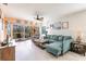 Well-lit living room with a ceiling fan, a comfortable seating area, and access to a screened lanai at 2040 Willow Hammock Cir # 208, Punta Gorda, FL 33983