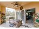 Inviting screened patio with a seating area, ceiling fan, and sliding glass doors to the living space at 2040 Willow Hammock Cir # 208, Punta Gorda, FL 33983
