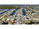 High-angle aerial view of a residential area highlighting the canal-lined streets and nearby boating opportunities at 21184 Edgewater Dr, Port Charlotte, FL 33952