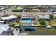 Aerial view of back yard of home showing pool, lanai, canal, and boat dock at 21184 Edgewater Dr, Port Charlotte, FL 33952