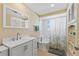 Bright bathroom with modern sink, cabinets, toilet and shower with decorated shower curtain at 21184 Edgewater Dr, Port Charlotte, FL 33952