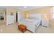Spacious bedroom featuring a large bed, dresser, and a view of the hallway at 21184 Edgewater Dr, Port Charlotte, FL 33952