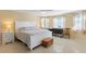 A beautifully decorated bedroom with a large white bed, ceiling fan and natural light at 21184 Edgewater Dr, Port Charlotte, FL 33952