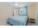 Cozy bedroom with a comfortable bed, soft lighting, and a view of the outdoors at 21184 Edgewater Dr, Port Charlotte, FL 33952