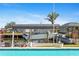 Waterfront boat dock with boat lift and pool in the backyard, offering a relaxing outdoor experience at 21184 Edgewater Dr, Port Charlotte, FL 33952