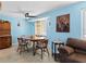 Bright dining room features wood table and chairs, ceiling fan and adjacent sitting area at 21184 Edgewater Dr, Port Charlotte, FL 33952