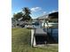 A peaceful waterside view features a private dock, boat lift, and lush greenery at 21184 Edgewater Dr, Port Charlotte, FL 33952