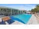 Lovely pool and patio area with outdoor seating, complemented by a screened lanai and boat dock at 21184 Edgewater Dr, Port Charlotte, FL 33952