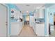 Galley kitchen featuring white cabinets and modern appliances at 21184 Edgewater Dr, Port Charlotte, FL 33952