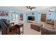 Spacious living room with modern ceiling fans, tile floors, a large television, and comfortable furniture at 21184 Edgewater Dr, Port Charlotte, FL 33952