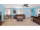 Bright living room with tile flooring, ceiling fans, and natural light from windows at 21184 Edgewater Dr, Port Charlotte, FL 33952