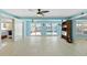 Open living room with tile flooring, sliders to pool, and a custom bar area for entertaining at 21184 Edgewater Dr, Port Charlotte, FL 33952