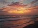 Beautiful sunset painting the sky in vibrant orange and pink colors over the ocean waves at 21422 Mallory Ave, Port Charlotte, FL 33952
