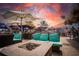 Inviting patio seating area with comfortable chairs, umbrellas, and a cozy fire pit for relaxing evenings at 21422 Mallory Ave, Port Charlotte, FL 33952