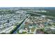 Aerial shot showcasing a vibrant waterfront community with canal access, single-Gathering homes, and well-manicured lawns at 240 Riviera Ct, Punta Gorda, FL 33950