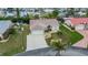 An aerial view shows the home's manicured lawn, and large driveway at 240 Riviera Ct, Punta Gorda, FL 33950