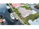 Aerial view of the waterfront home featuring a private dock, boat, lush landscaping, and inviting outdoor spaces at 240 Riviera Ct, Punta Gorda, FL 33950