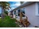 Backyard with stairs, deck, and lush green grass at 240 Riviera Ct, Punta Gorda, FL 33950