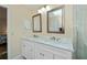 Bright bathroom featuring double sinks with a large shower and bright natural light at 240 Riviera Ct, Punta Gorda, FL 33950