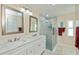 Bright bathroom features a double sink vanity, updated shower and modern fixtures at 240 Riviera Ct, Punta Gorda, FL 33950