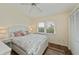 Comfortable bedroom featuring a ceiling fan, large window and closet with wood floors at 240 Riviera Ct, Punta Gorda, FL 33950