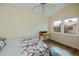 Bright bedroom features a ceiling fan, natural light, a desk, and wood-look flooring at 240 Riviera Ct, Punta Gorda, FL 33950