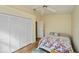 Clean bedroom featuring a ceiling fan and large closet; wood flooring throughout at 240 Riviera Ct, Punta Gorda, FL 33950
